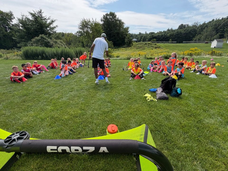 Campers gathered around a coach between sessions