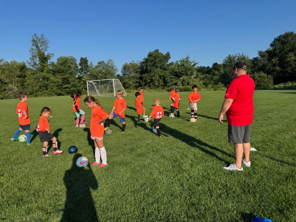 Campers playing a small-sided game with a coach