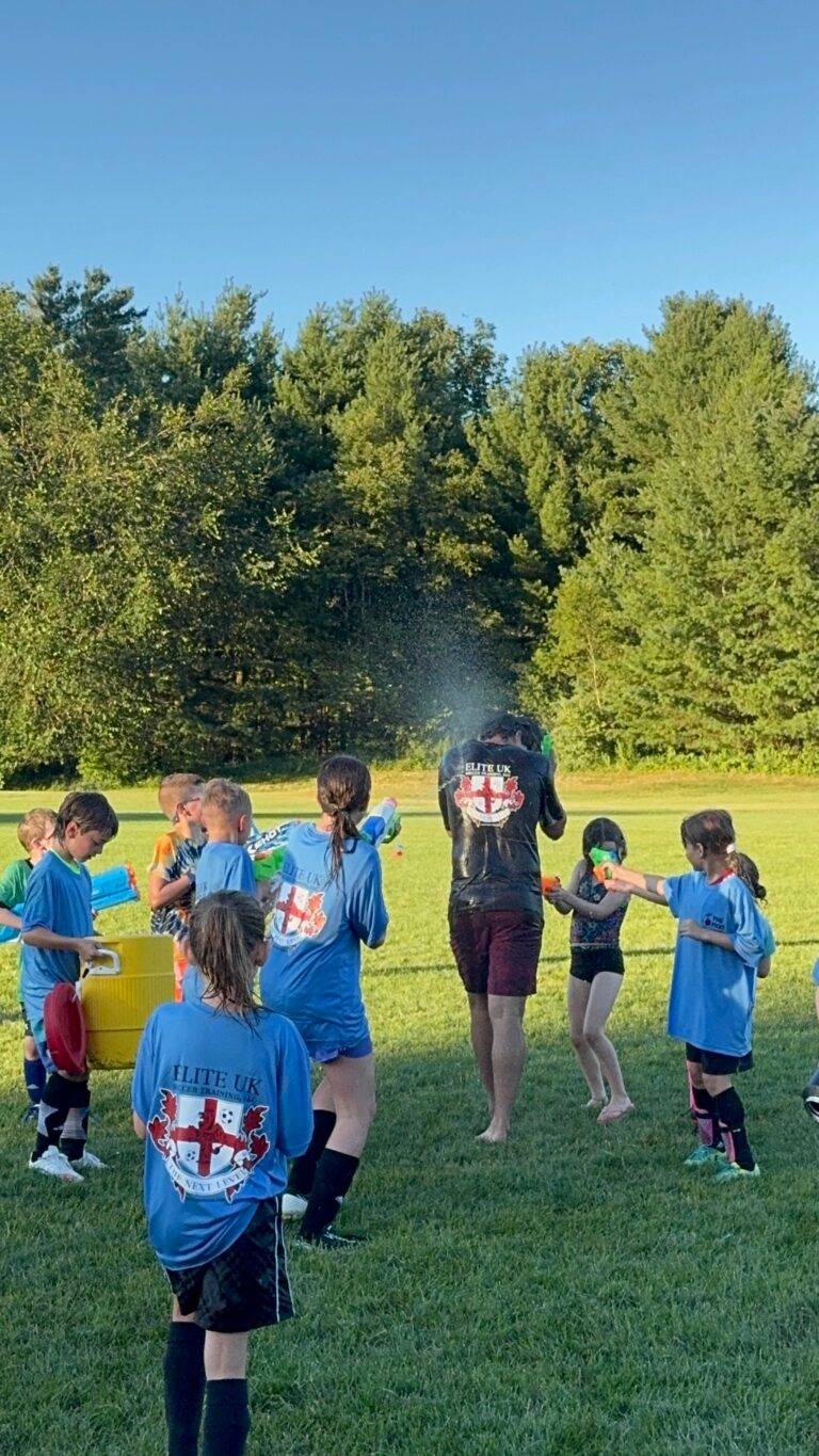 Campers and coaches in a water-balloon battle