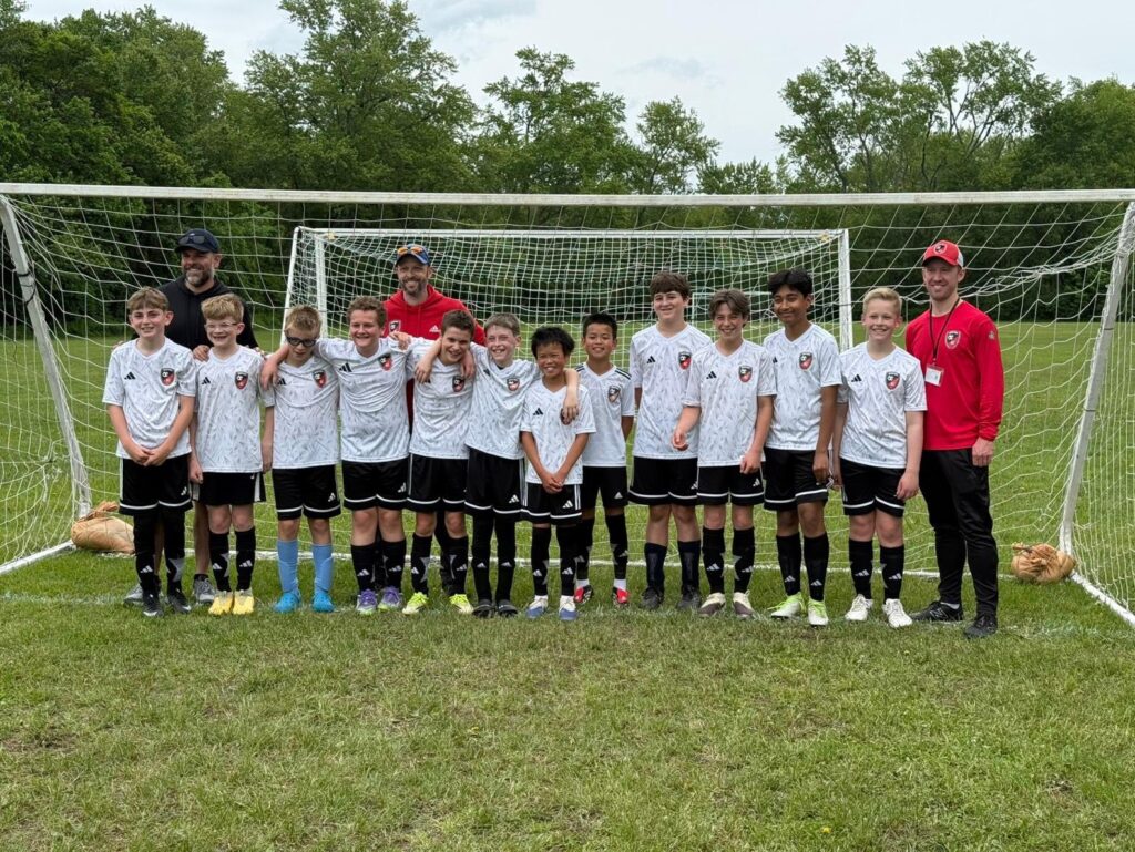 BAC boys travel team with their coaches after a game